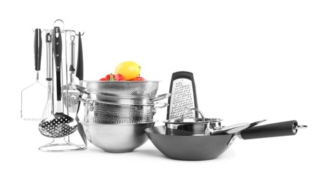 Dishware, cooking utensils with vegetables and lemon isolated on white