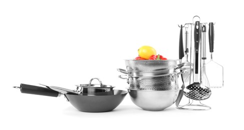 Dishware, cooking utensils with vegetables and lemon isolated on white