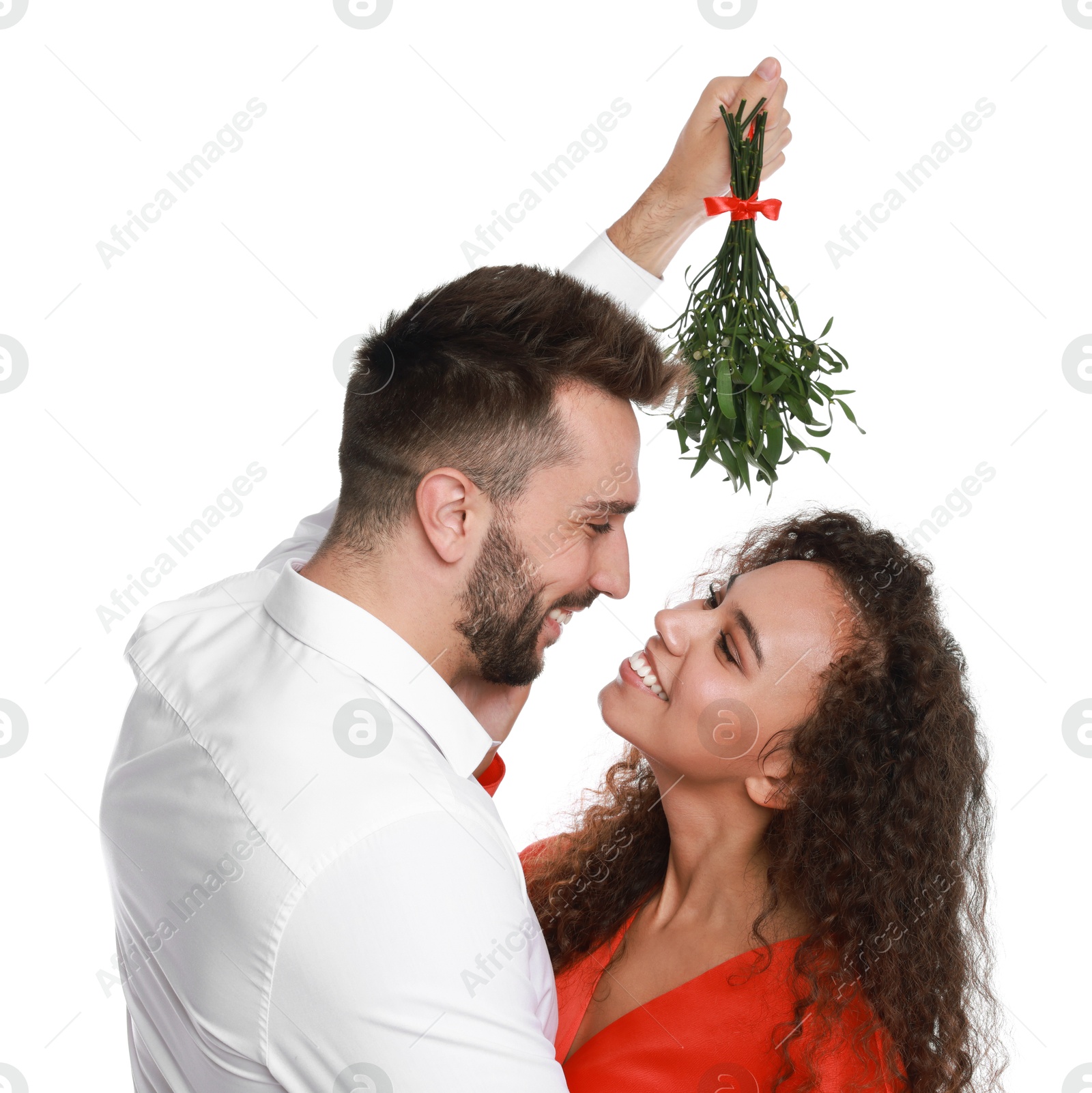 Photo of Lovely couple under mistletoe bunch on white background