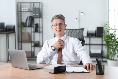 Photo of Portrait of businessman at table in office