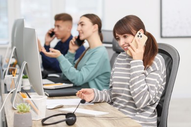 Sales department. People calling to clients in office, selective focus