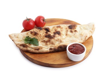 Photo of Delicious calzone with ketchup, fresh tomatoes and parsley isolated on white