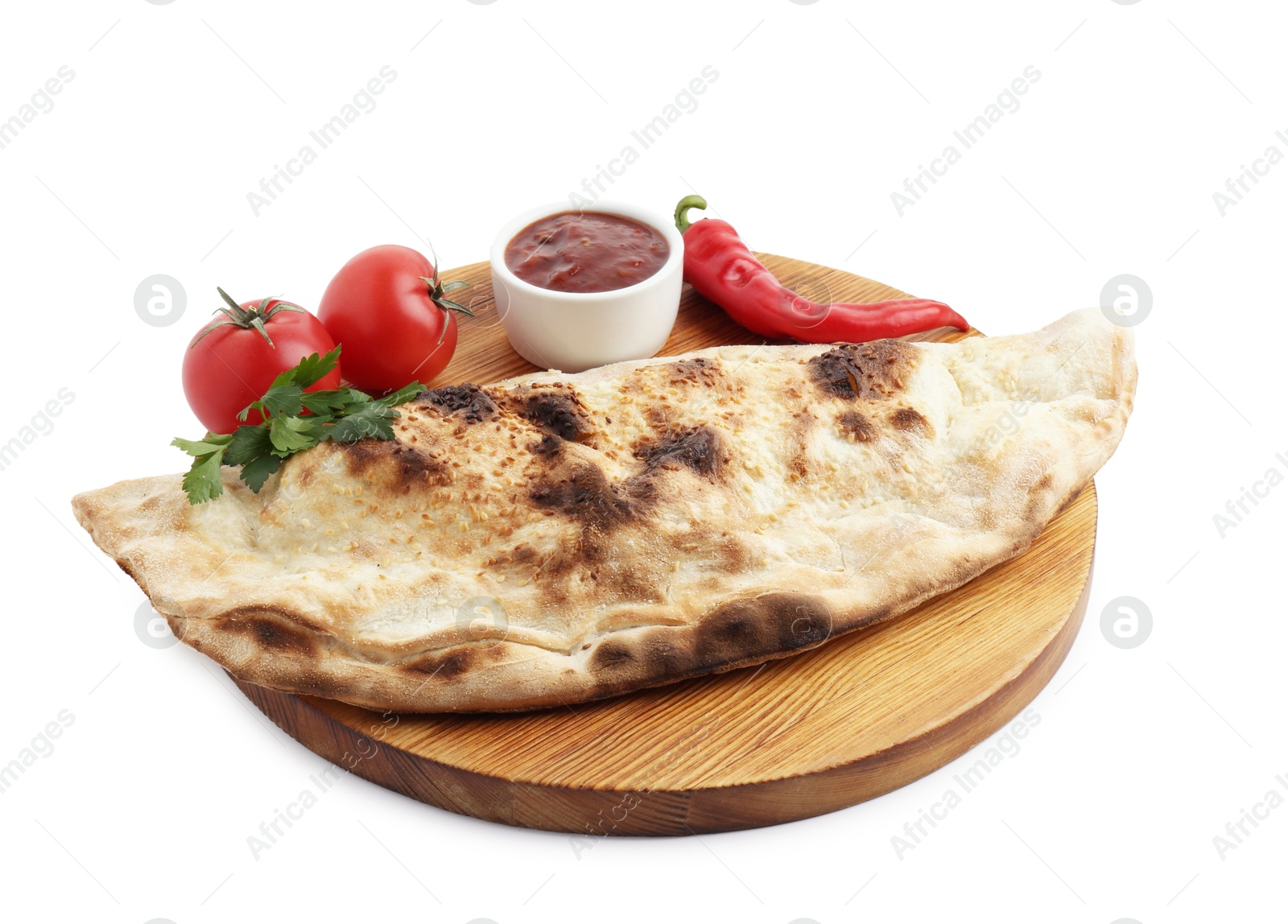 Photo of Delicious calzone with ketchup, fresh tomatoes and chili pepper isolated on white