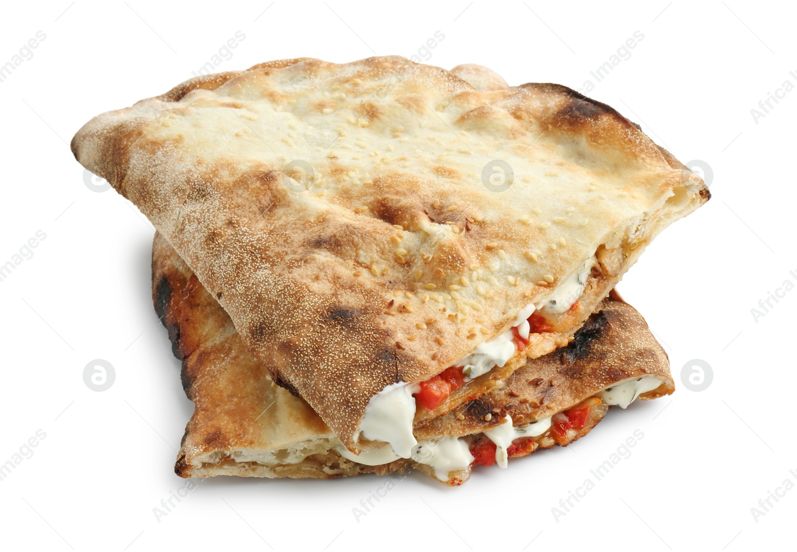 Photo of Halves of tasty calzone with meat, cheese, sauce and tomato isolated on white