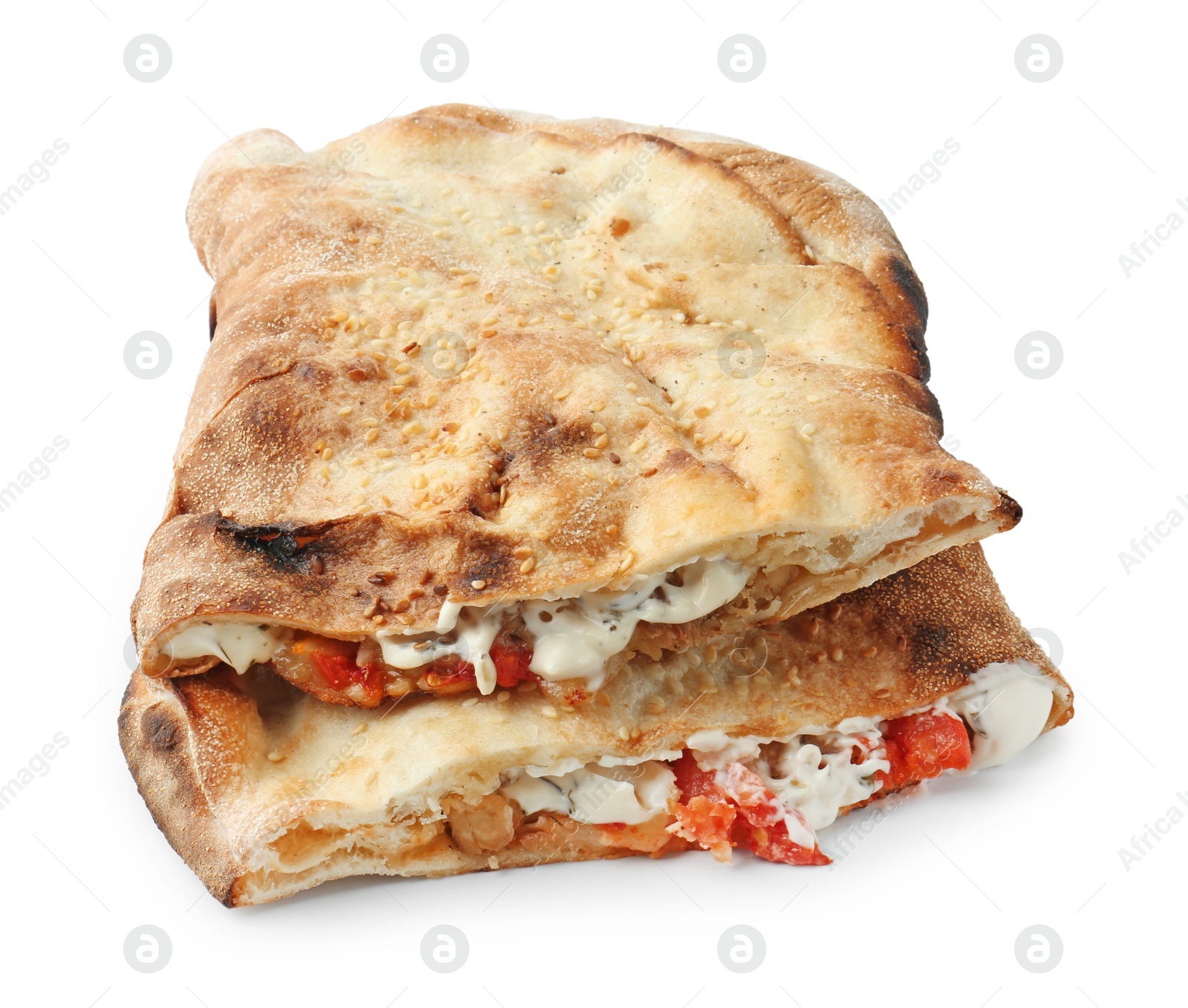 Photo of Halves of tasty calzone with meat, cheese, sauce and tomato isolated on white