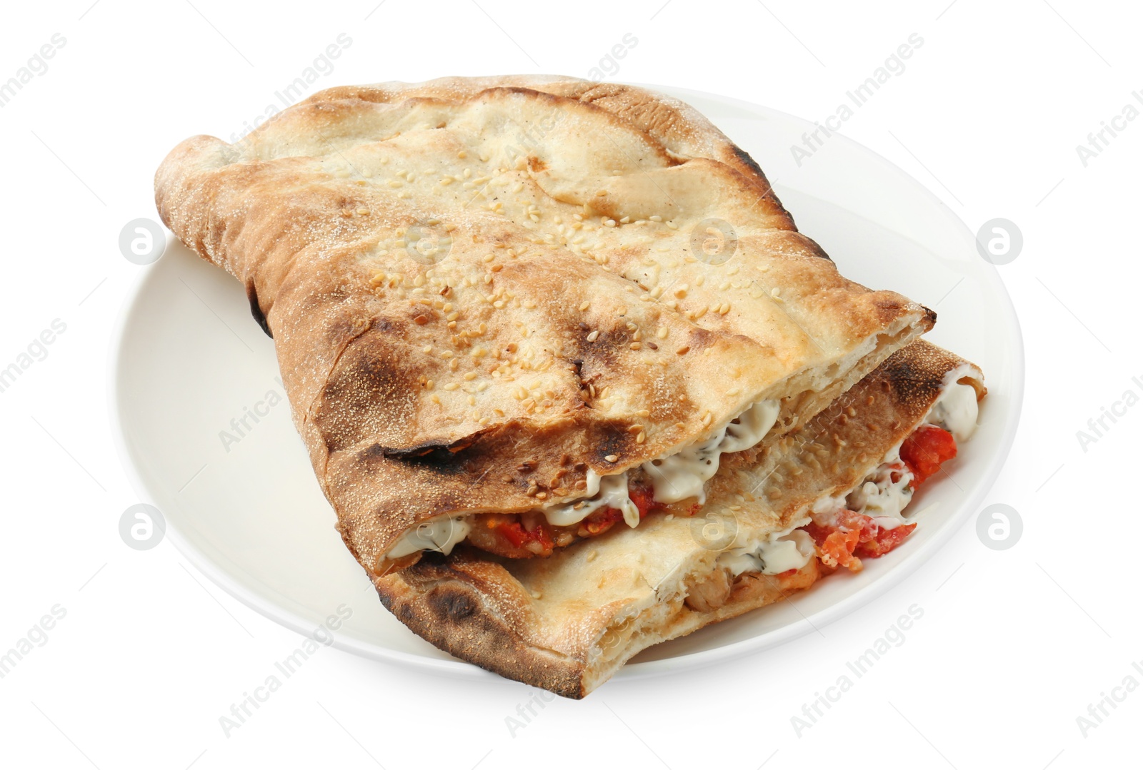 Photo of Halves of tasty calzone with meat, cheese, sauce and tomato isolated on white