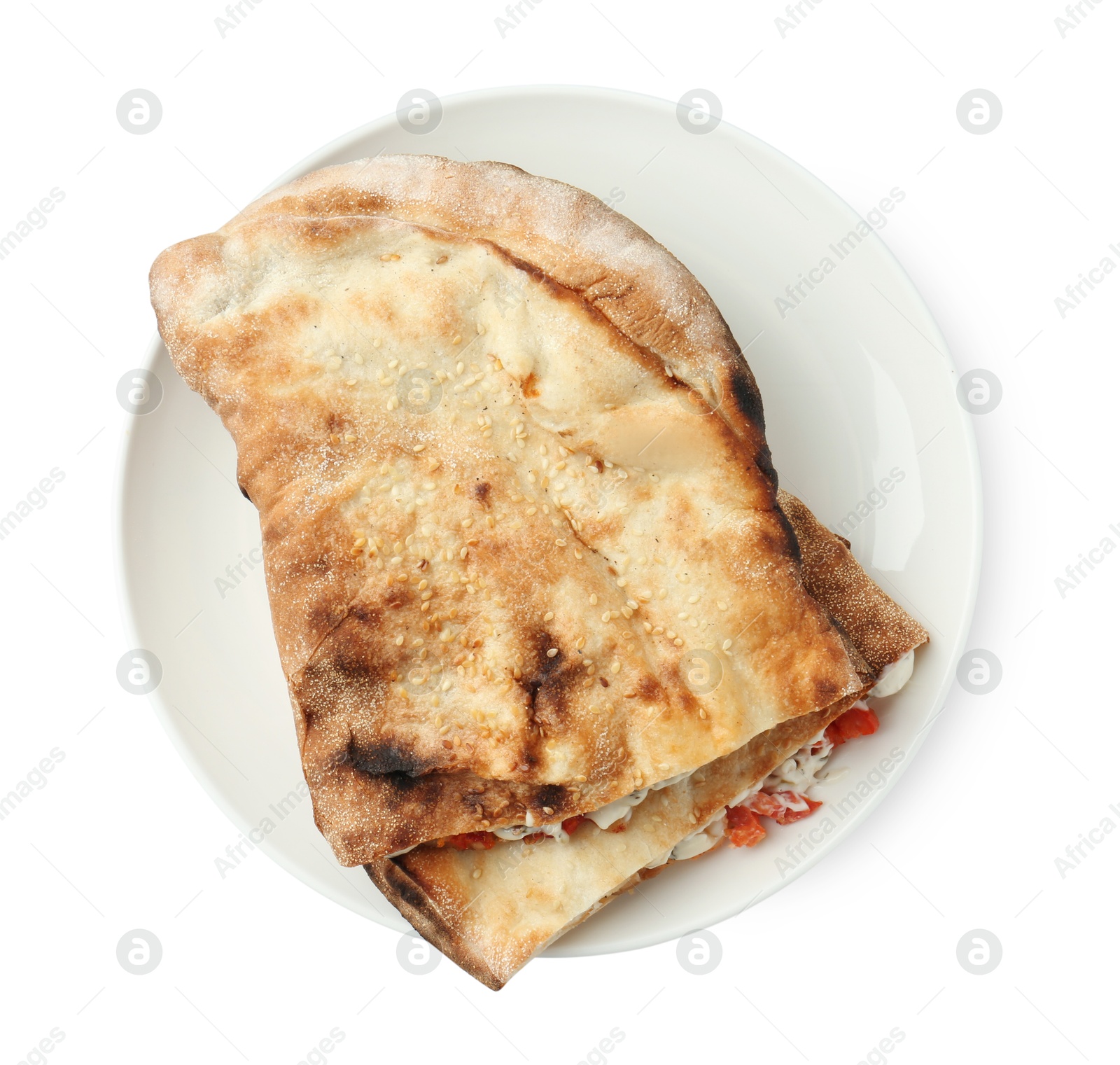 Photo of Halves of tasty calzone with meat, cheese, sauce and tomato isolated on white, top view