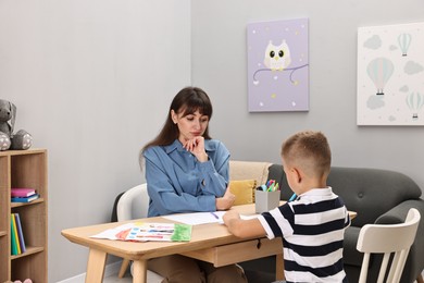 Photo of Therapist working with little boy in autism treatment center