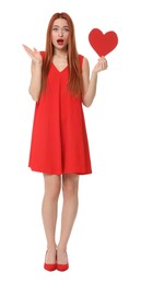 Photo of Emotional young woman in red dress with paper heart on white background