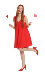 Photo of Young woman in red dress with paper hearts on white background