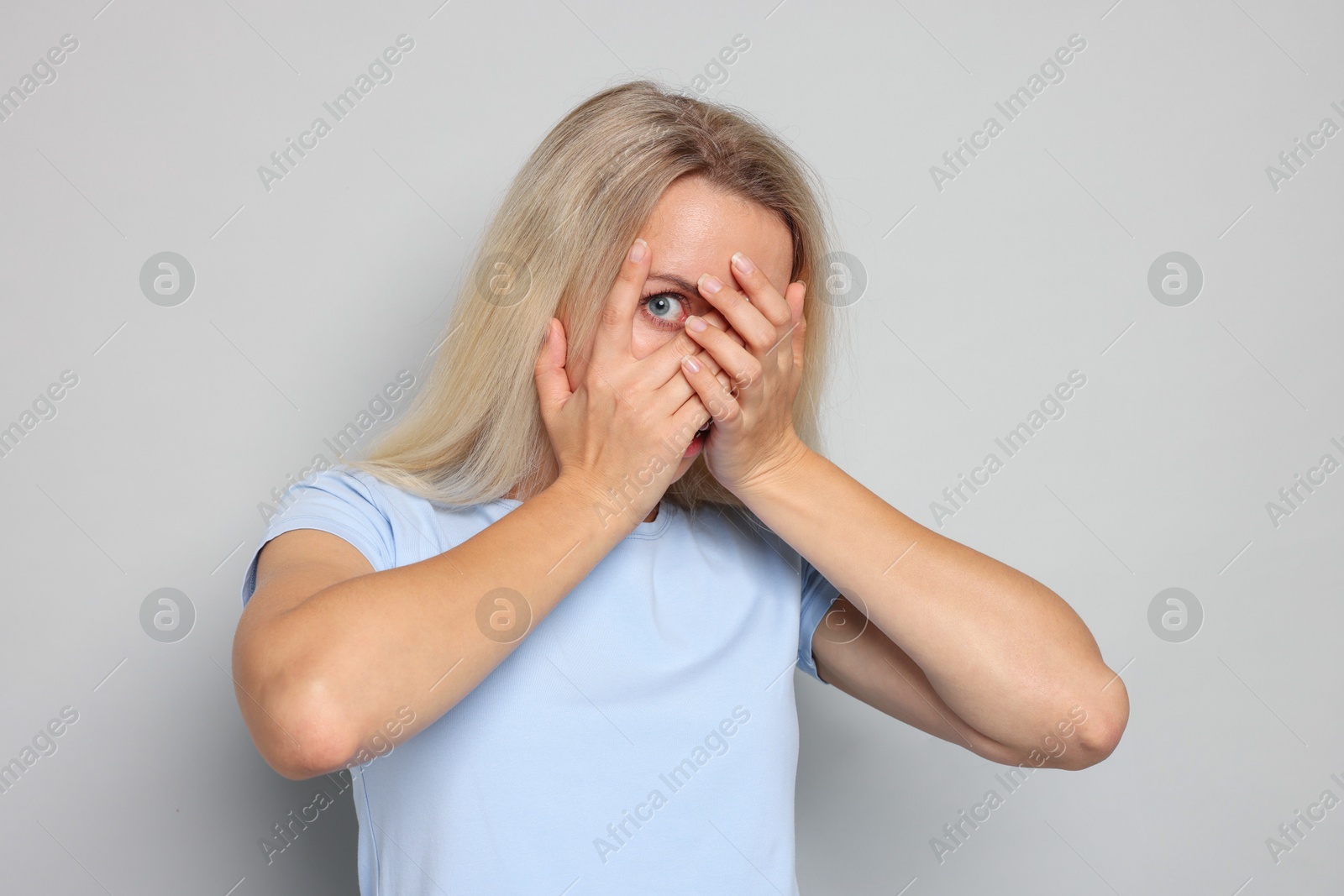 Photo of Portrait of scared woman on gray background