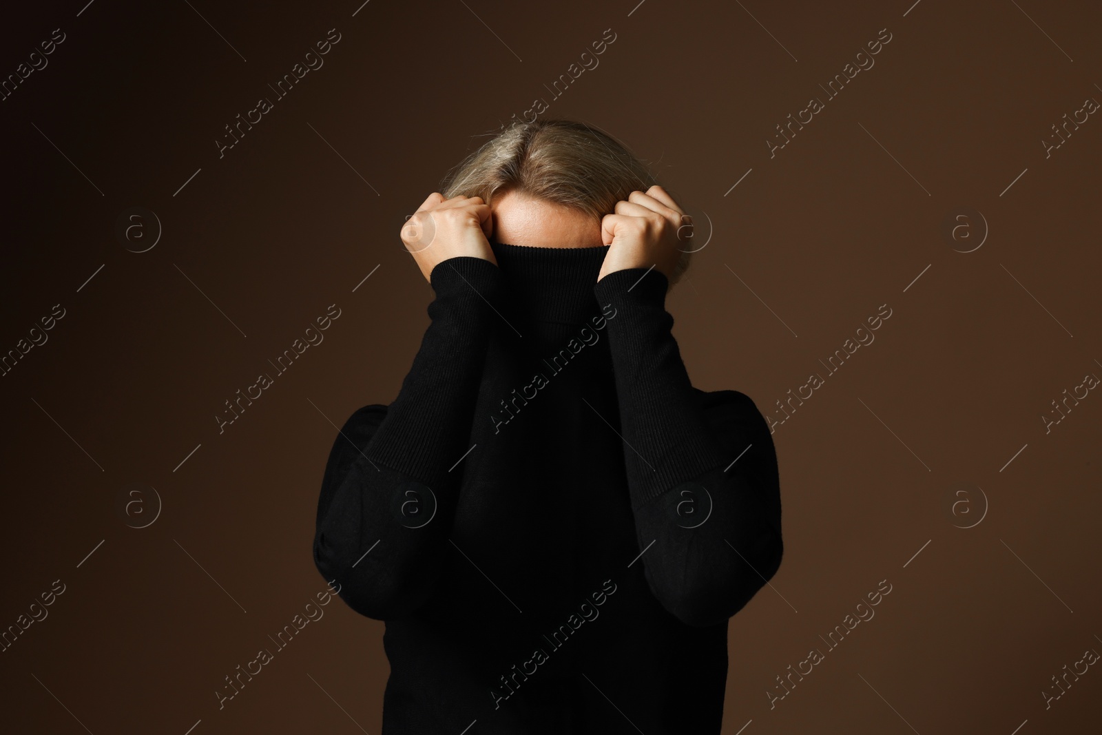 Photo of Portrait of scared woman on brown background