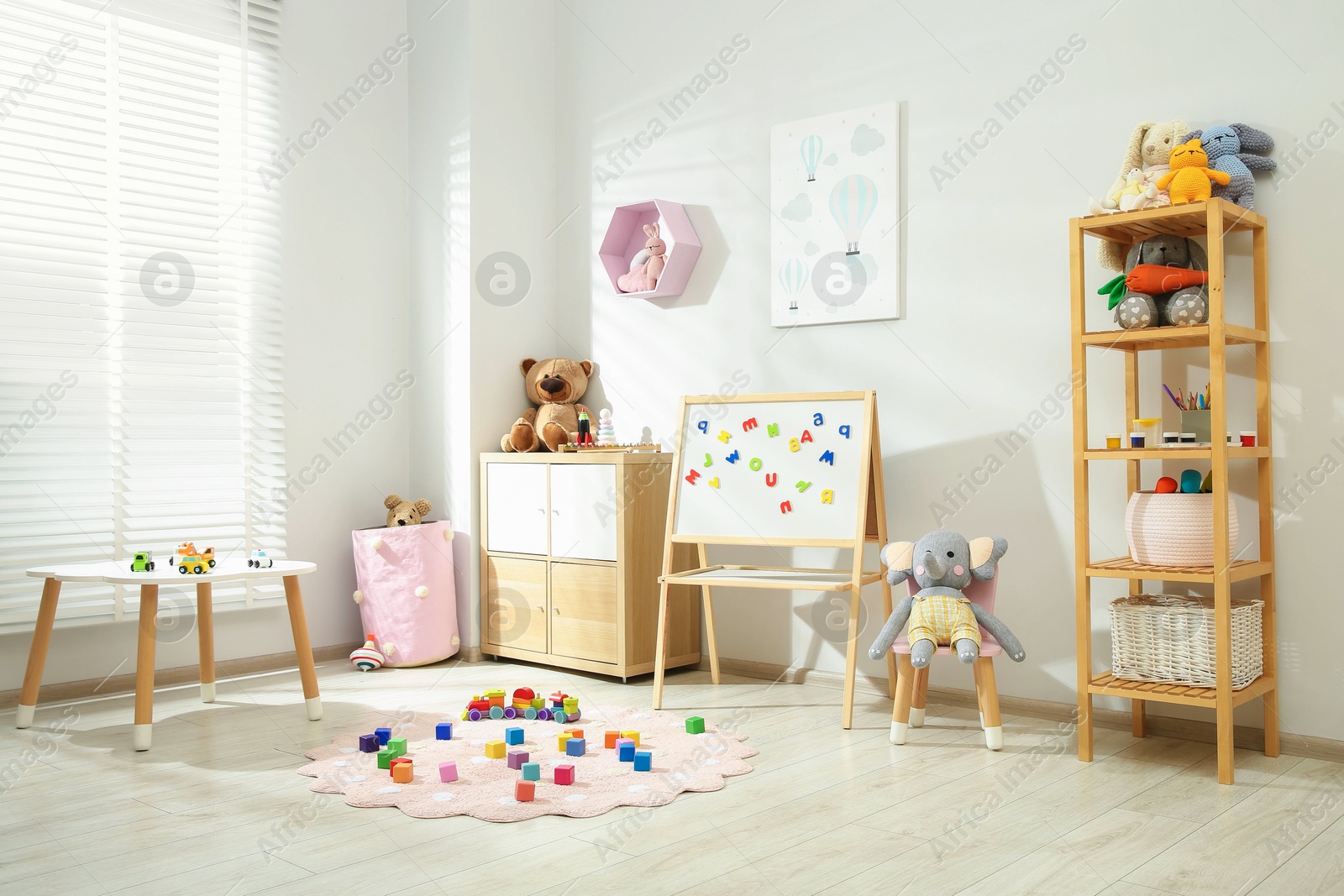 Photo of Beautiful child's room interior with toys and stylish furniture