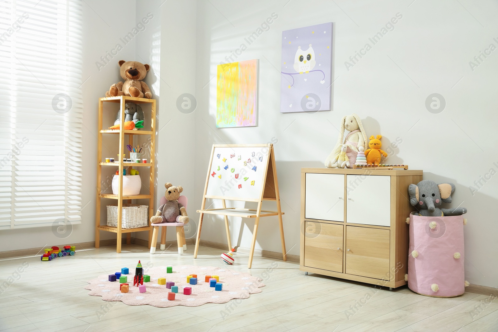 Photo of Beautiful child's room interior with toys and stylish furniture