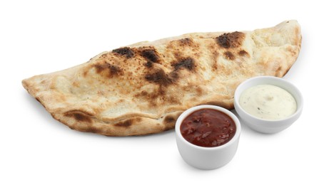 Photo of Delicious calzone with sauces isolated on white