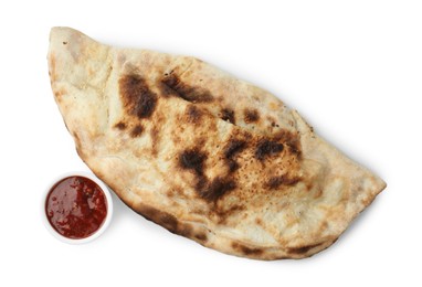 Photo of One delicious calzone with ketchup isolated on white, top view