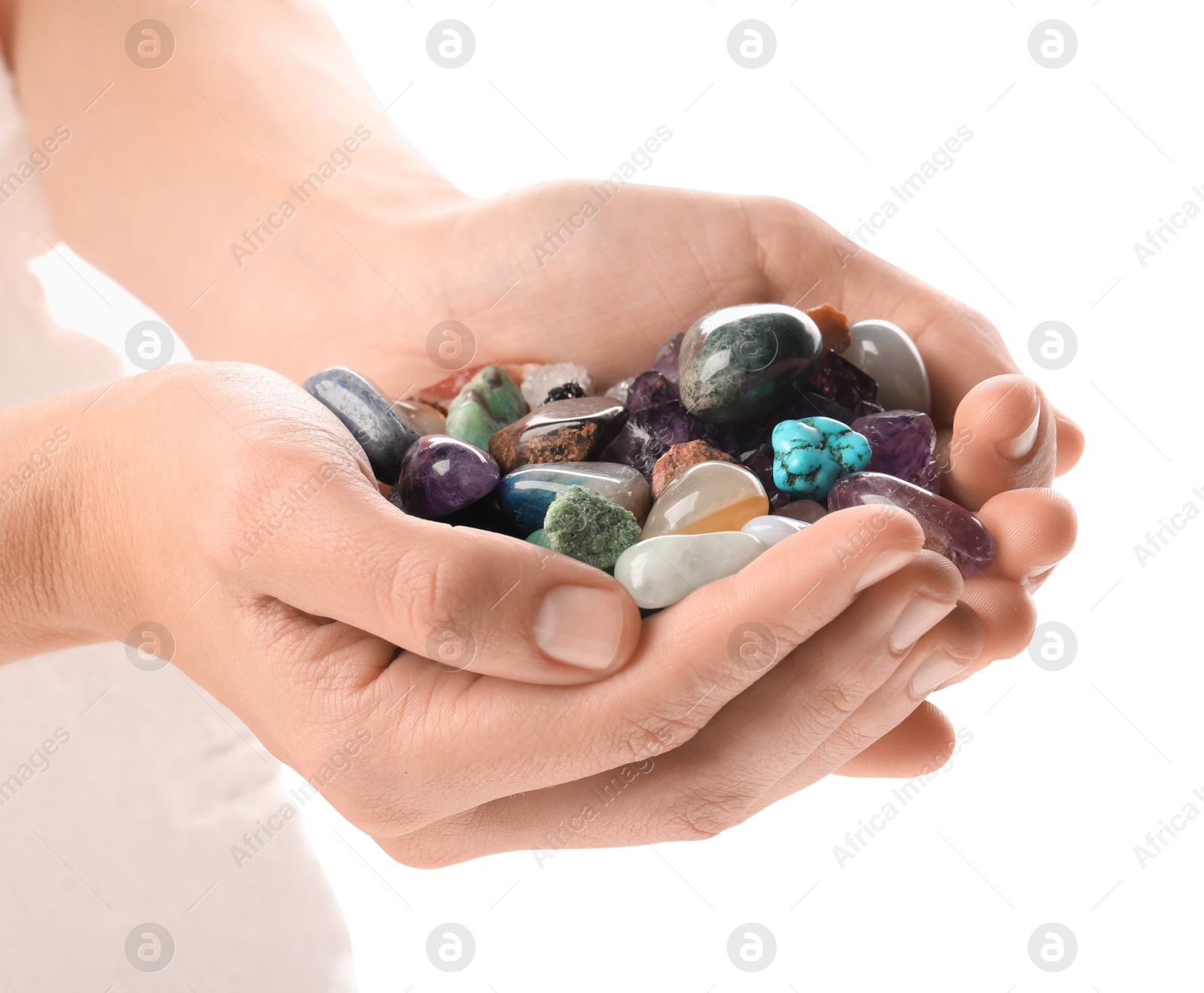 Photo of Woman holding different natural mineral stones on white background, closeup