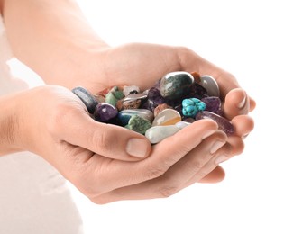 Photo of Woman holding different natural mineral stones on white background, closeup