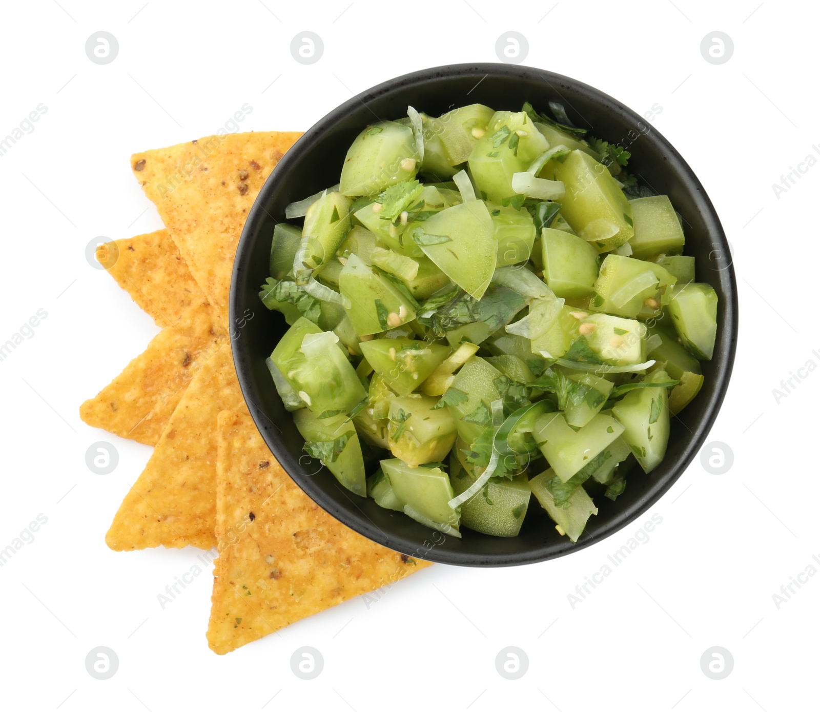 Photo of Delicious homemade green salsa with nachos isolated on white, top view