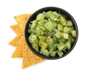 Photo of Delicious homemade green salsa with nachos isolated on white, top view