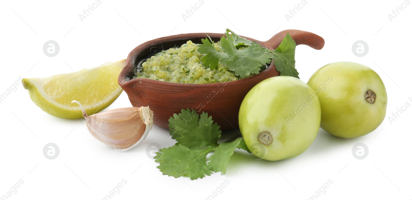 Photo of Delicious homemade green salsa and ingredients isolated on white