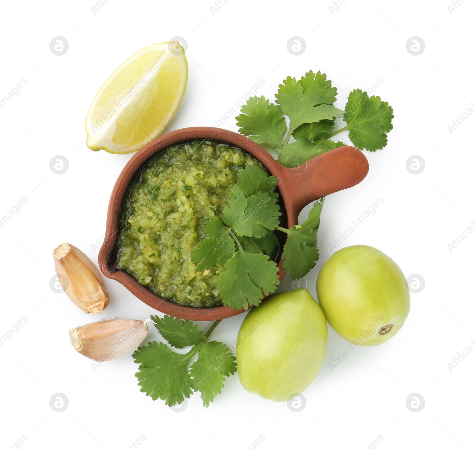 Photo of Delicious homemade green salsa and ingredients isolated on white, top view