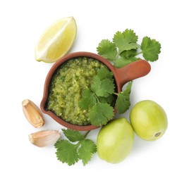 Photo of Delicious homemade green salsa and ingredients isolated on white, top view