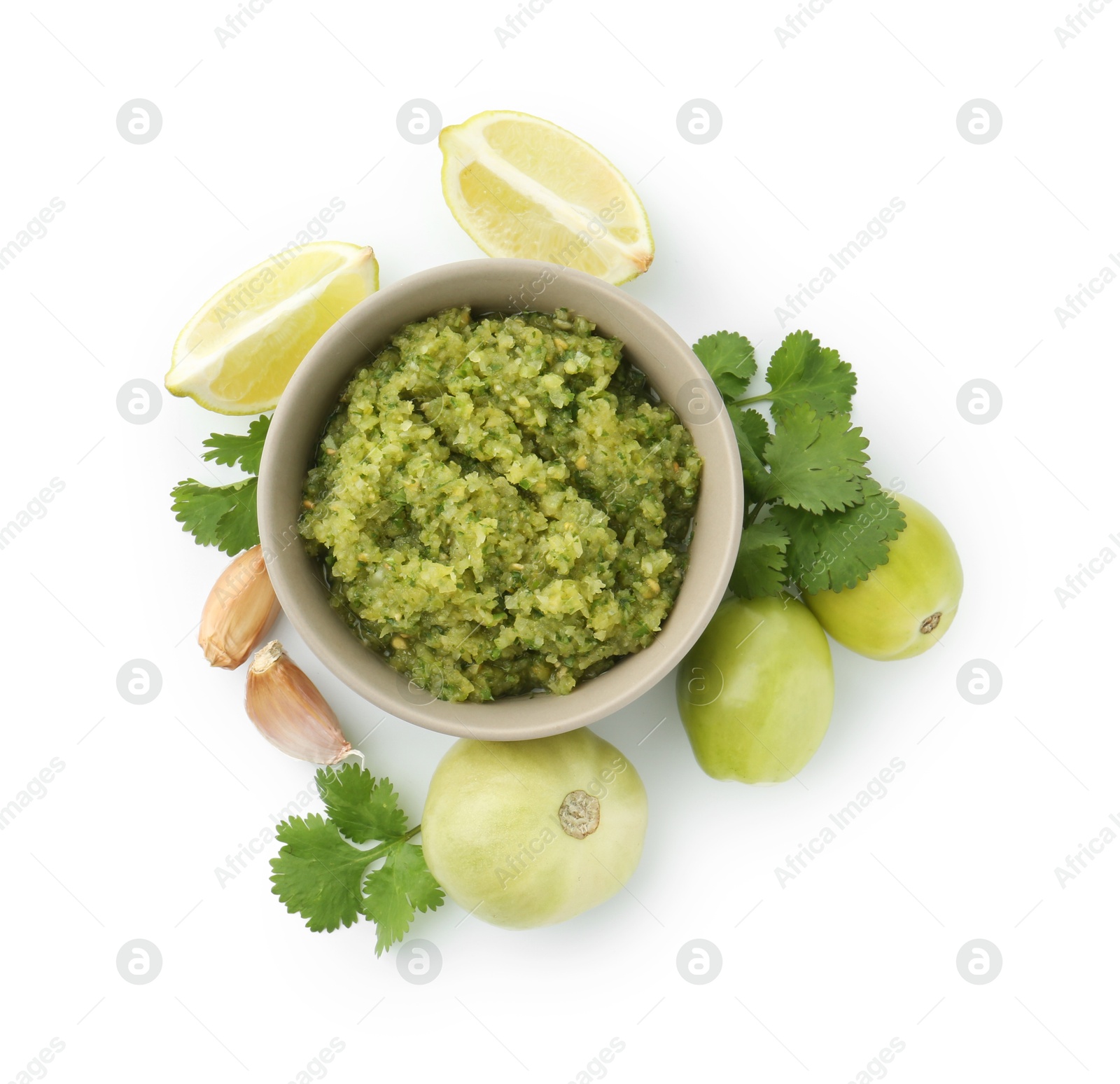 Photo of Delicious homemade green salsa and ingredients isolated on white, top view