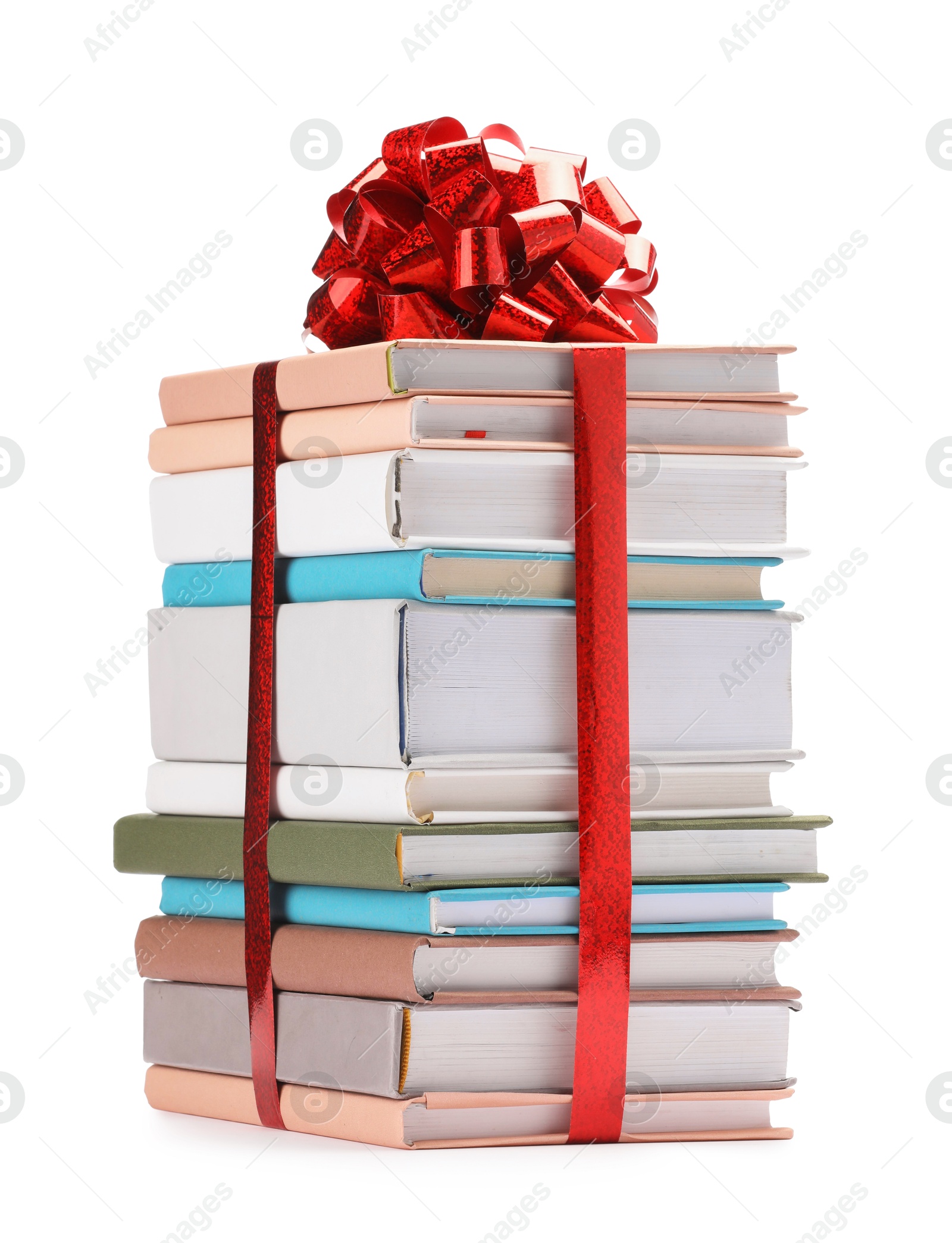 Photo of Stack of books with red bow as gift isolated on white