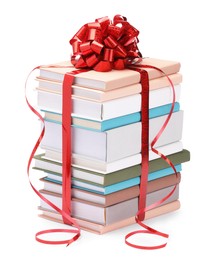 Photo of Stack of books with red bow as gift isolated on white