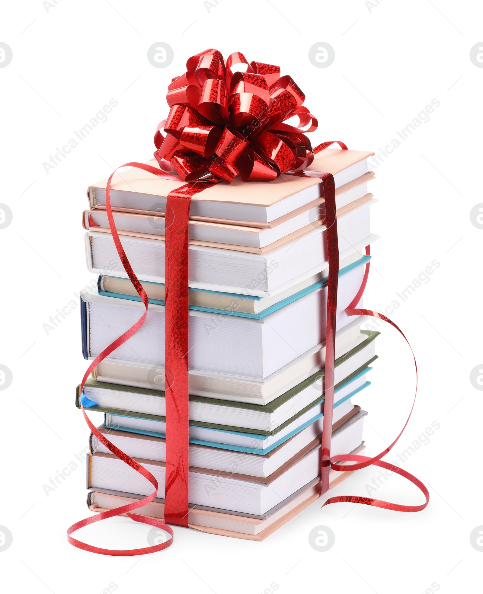 Photo of Stack of books with red bow as gift isolated on white