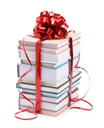 Photo of Stack of books with red bow as gift isolated on white