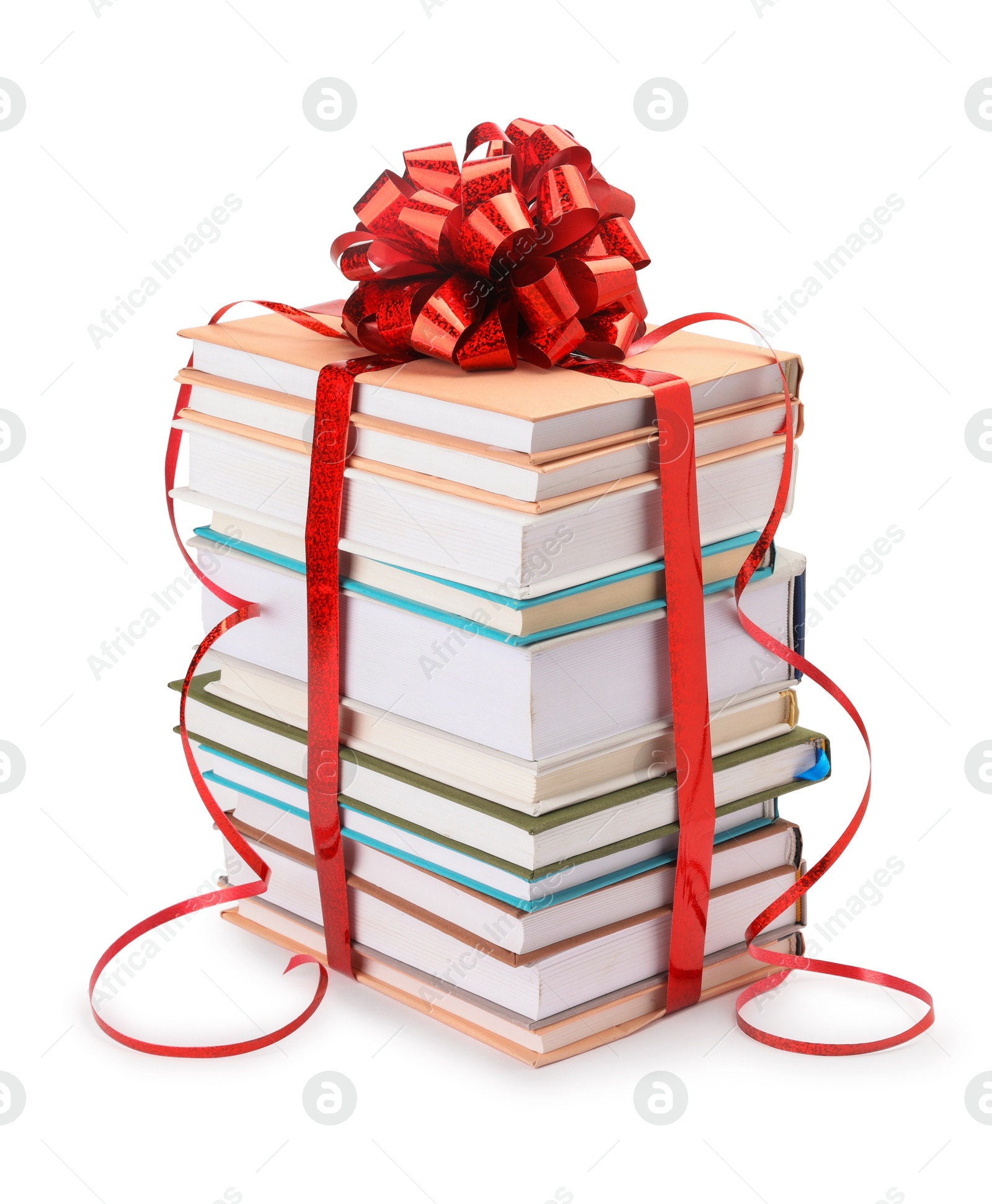 Photo of Stack of books with red bow as gift isolated on white