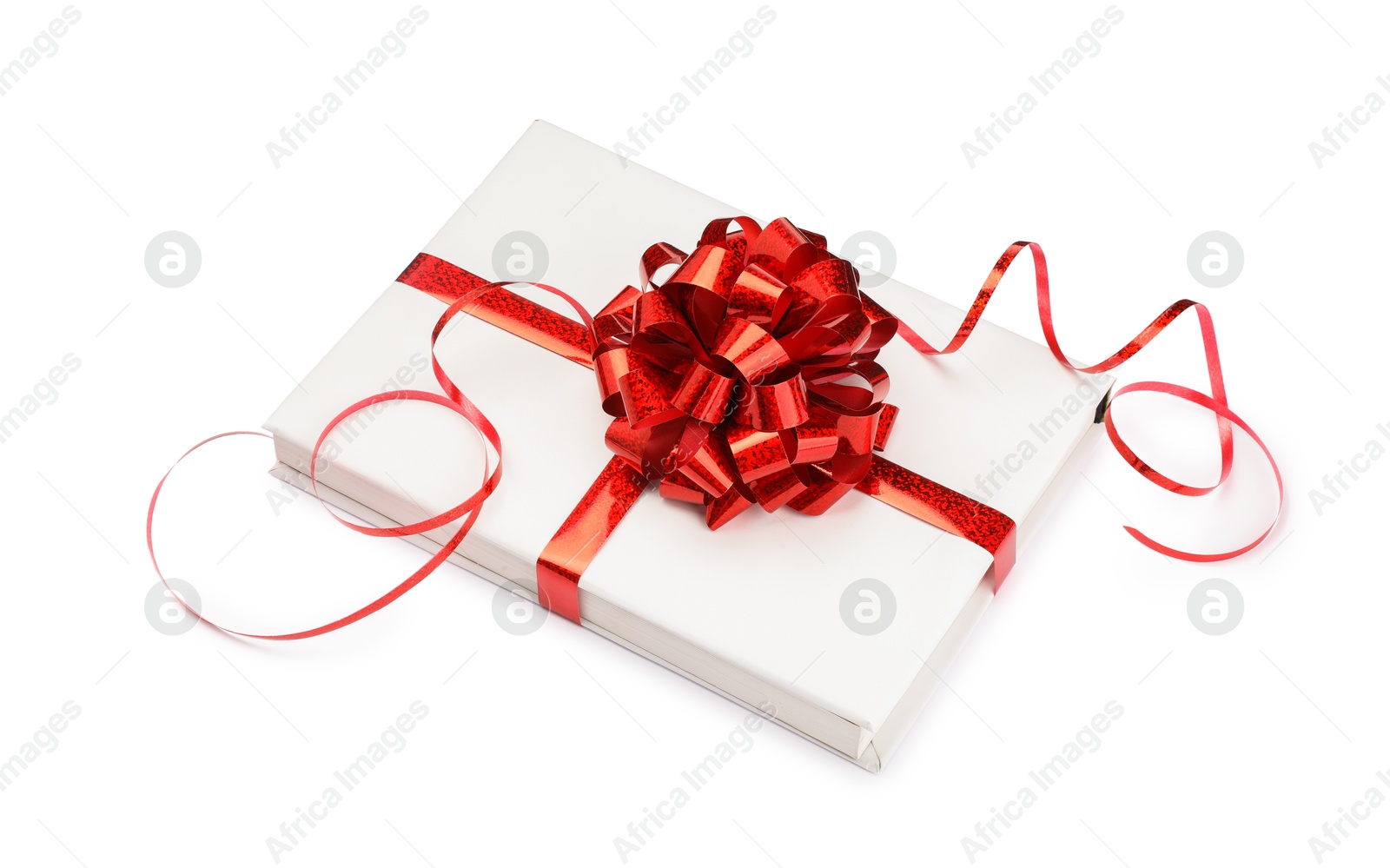 Photo of One book with red bow as gift isolated on white