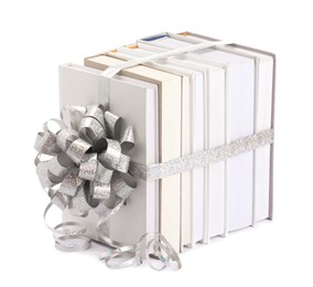 Photo of Books with silver bow as gift isolated on white