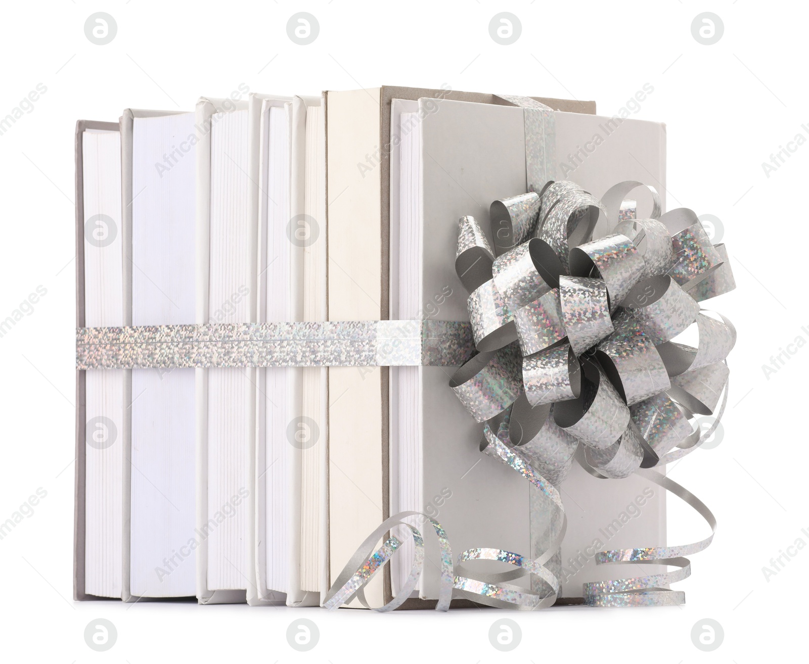 Photo of Books with silver bow as gift isolated on white