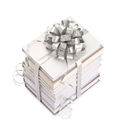 Photo of Stack of books with silver bow as gift isolated on white