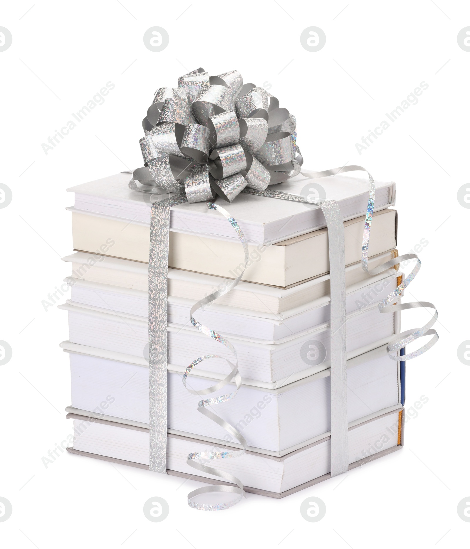 Photo of Stack of books with silver bow as gift isolated on white