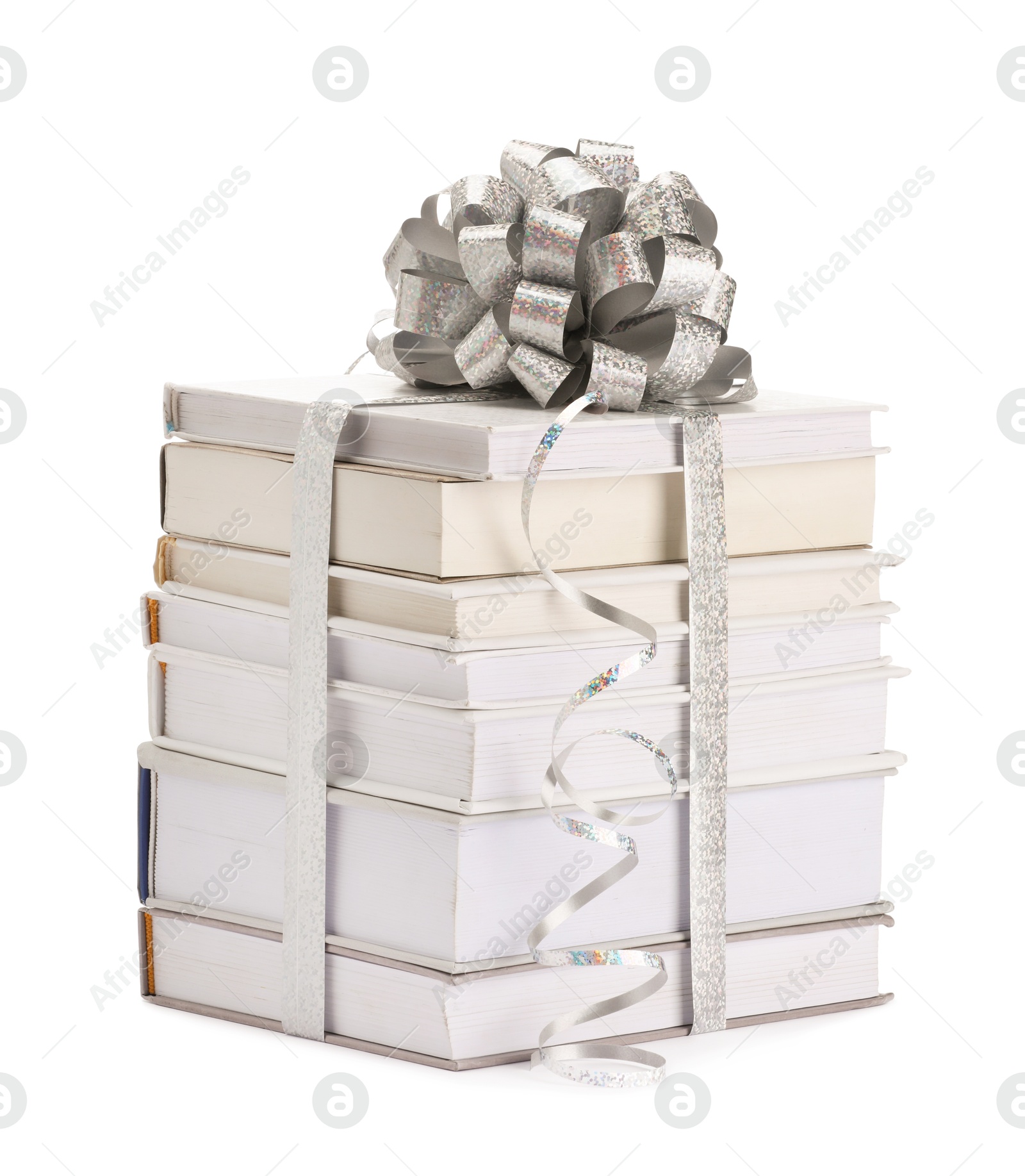 Photo of Stack of books with silver bow as gift isolated on white