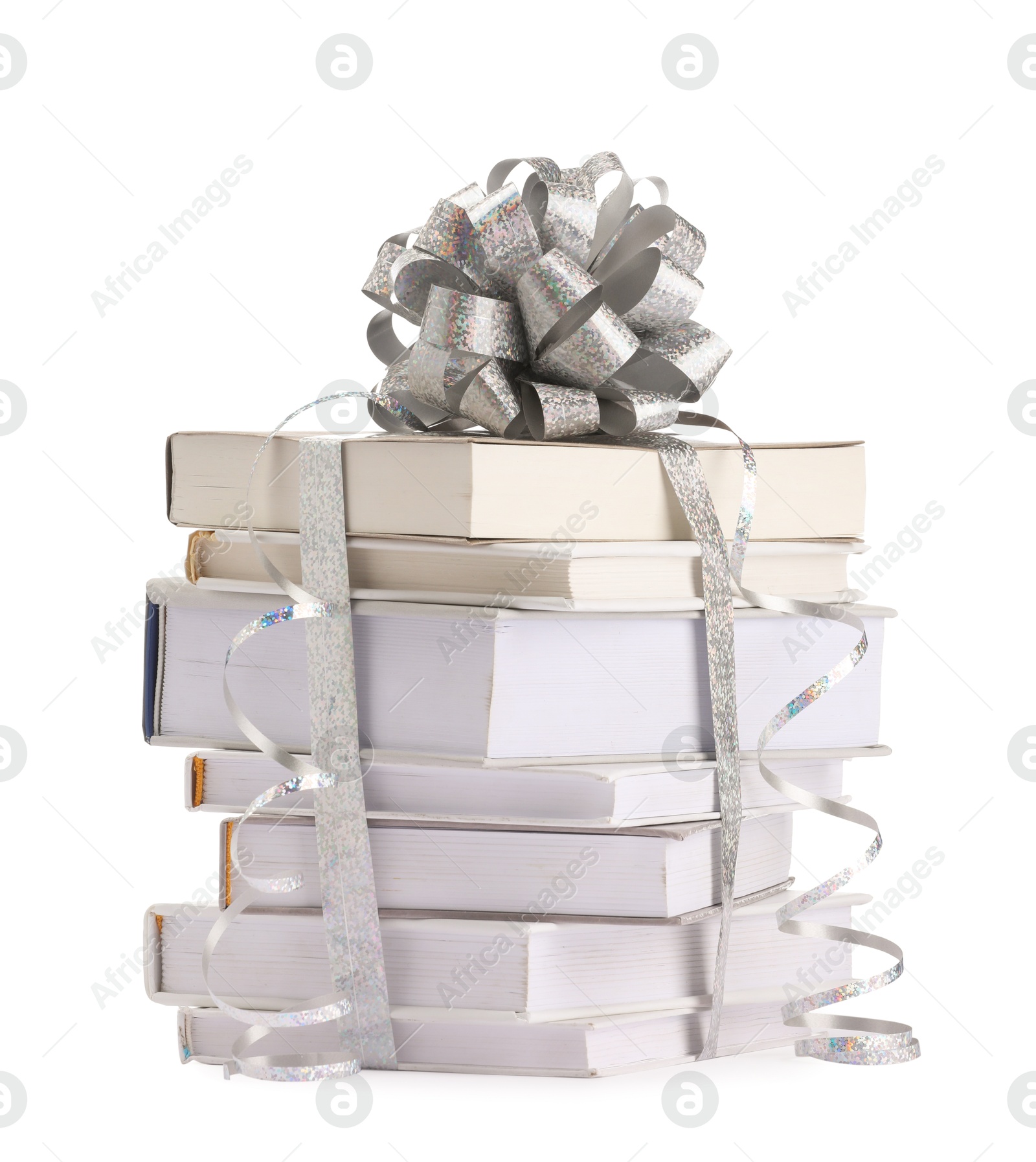 Photo of Stack of books with silver bow as gift isolated on white