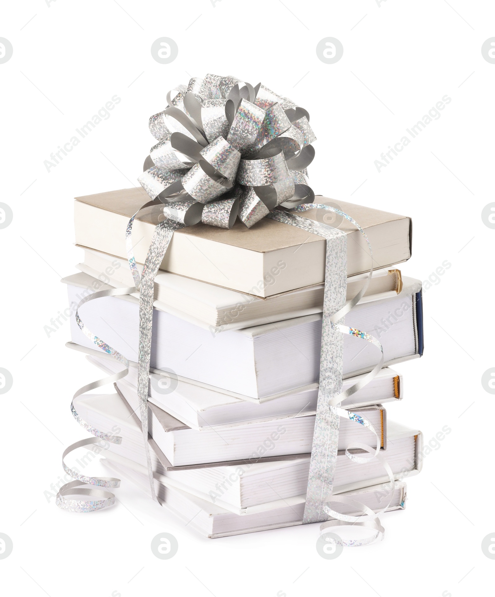 Photo of Stack of books with silver bow as gift isolated on white