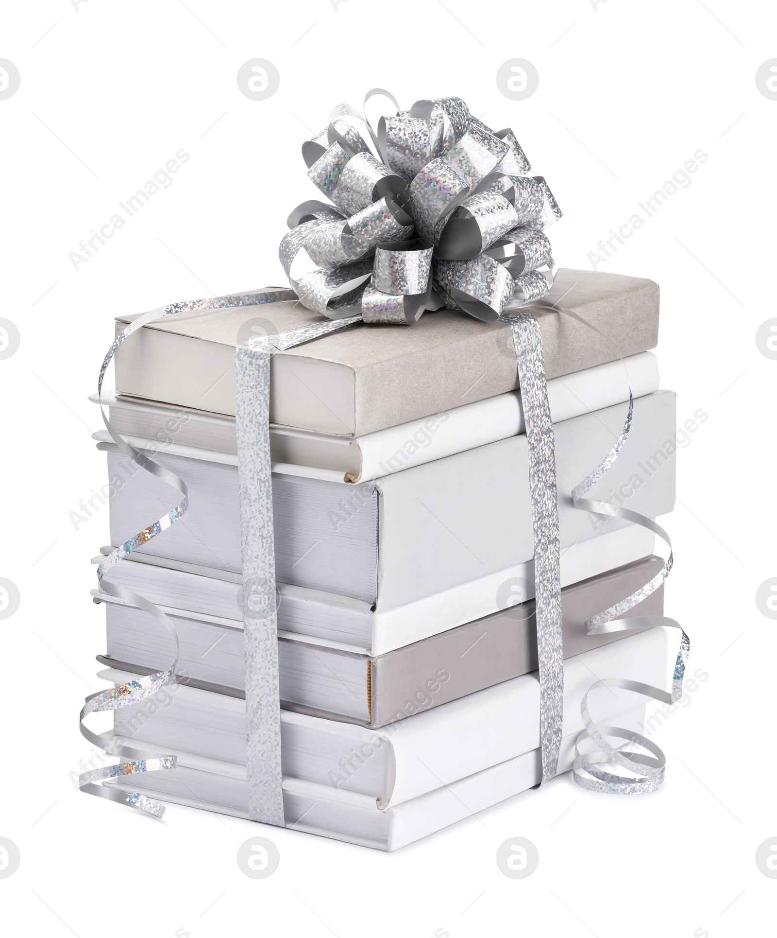 Photo of Stack of books with silver bow as gift isolated on white