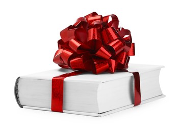 Photo of One book with red bow as gift isolated on white