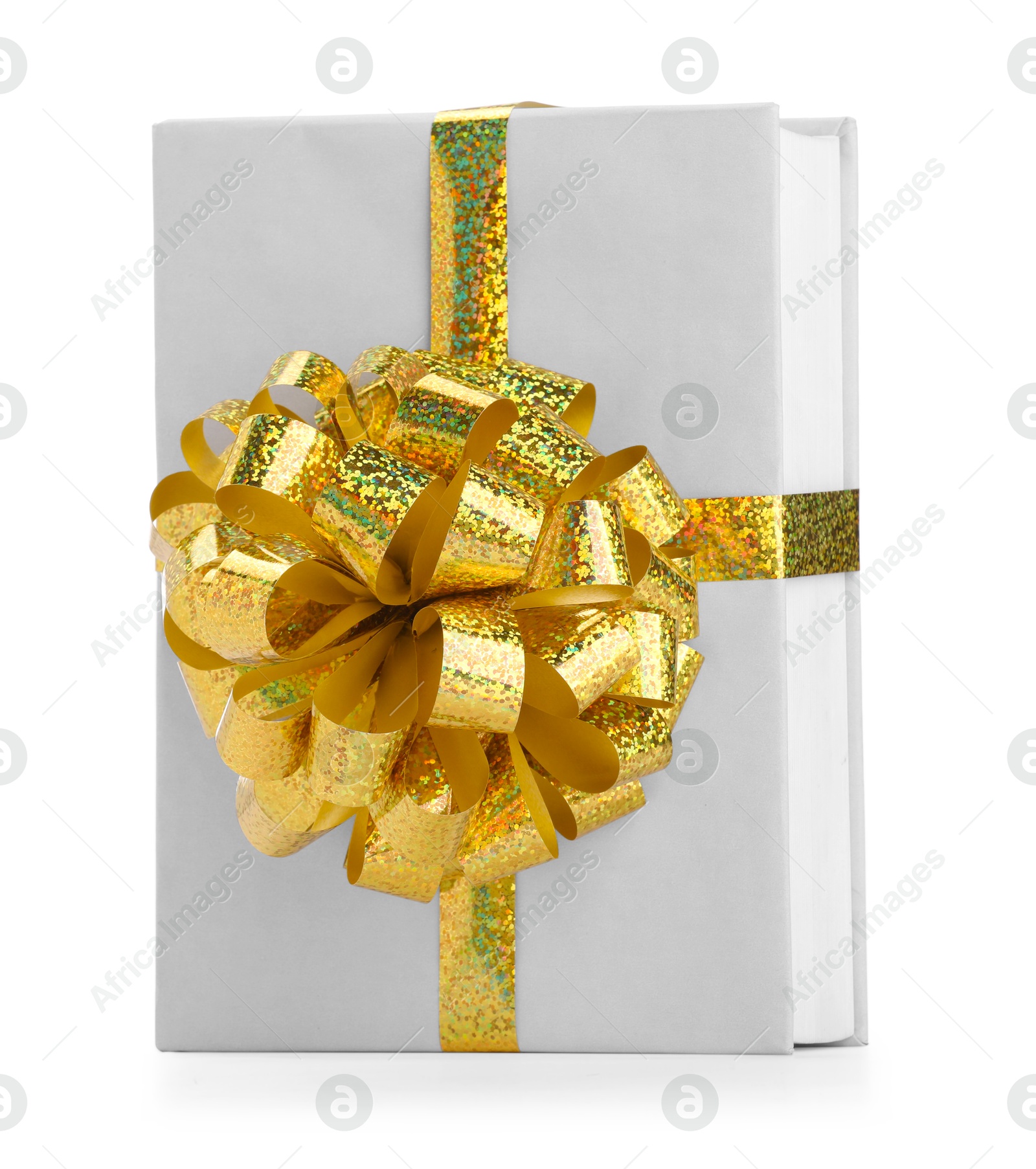 Photo of One book with golden bow as gift isolated on white