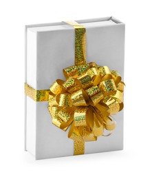 Photo of One book with golden bow as gift isolated on white