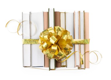 Photo of Books with golden bow as gift isolated on white, top view