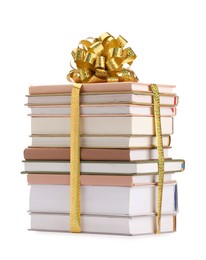 Photo of Stack of books with golden bow as gift isolated on white