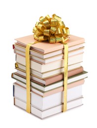 Photo of Stack of books with golden bow as gift isolated on white