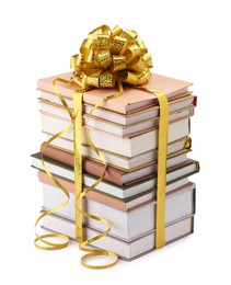 Photo of Stack of books with golden bow as gift isolated on white