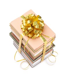 Photo of Stack of books with golden bow as gift isolated on white